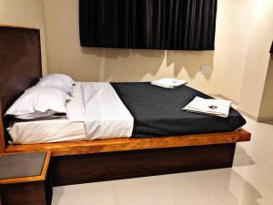 a bed with two towels on top of it at SKYLARK STUDIO 1 in Belgaum