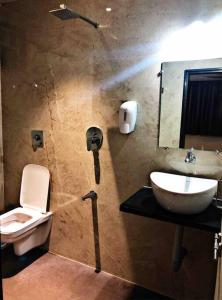 a bathroom with a toilet and a sink at SKYLARK STUDIO 1 in Belgaum