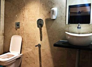 a bathroom with a toilet and a sink at SKYLARK STUDIO 1 in Belgaum