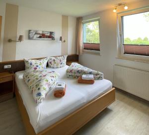 a bedroom with a bed with two cell phones on it at Pension Müritzblick in Gotthun