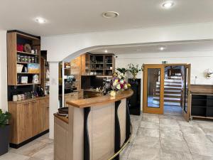 a kitchen with a counter in the middle of a room at Golden Golem hotel & Spa in Prague