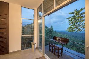 a glass house with a view at Treehouse Chalets in Belihul Oya