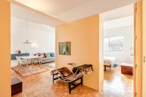 a living room with a chair and a table at VIVA Nanda's Place in Porto