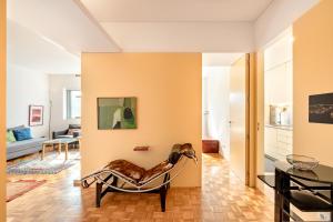 a living room with a chair and a table at VIVA Nanda's Place in Porto