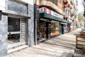 an empty street in a city with a store at VIVA Nanda's Place in Porto
