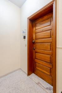 a wooden door in the corner of a room at VIVA Nanda's Place in Porto