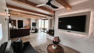 a living room with a large television on a brick wall at Lucky Crane Villas in McGregor