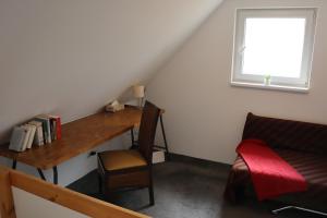 a room with a desk and a chair and a window at Domeček u Brna, klid & wi-fi in Bílovice nad Svitavou