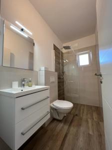 a bathroom with a toilet and a sink and a shower at Apartments Mamma Mia in Orebić