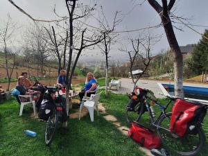 a group of people sitting at a table with their bikes at Tent Camping in Sarajevo