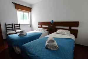 duas camas com toalhas em um quarto em Apartamento Brisa Mar em Albufeira