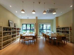 a dining room with a table and chairs and bookshelves at seaview beach4-13pax ksl CIQ midvalley johor bahru in Johor Bahru
