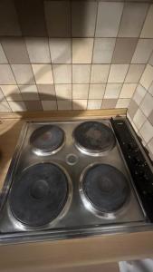 a stove top with four burners on it in a kitchen at Sweet Belgica in Brussels