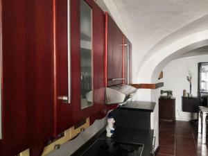 uma cozinha com armários vermelhos e uma bancada em Casa térrea no centro da Cidade, antiga adega! em Borba