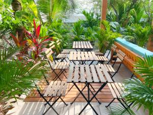 a group of chairs sitting on a deck with plants at Villa Laguna Maldives in Fulhadhoo