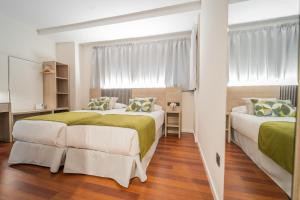 a bedroom with two beds in a room at SAHERA HOTEL Boutique in Telde