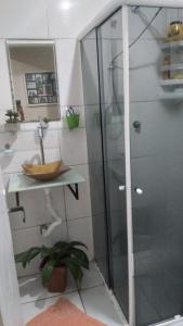 a bathroom with a shower with a sink and a toilet at Casa tipo sobrado. in Arraial do Cabo