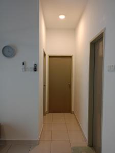a hallway with a door and a tile floor at Homesbyfs Youth City KLIA in Nilai