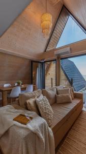 a living room with a couch and a large window at Casas da Madrinha in Arcos de Valdevez +87 photos