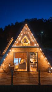 a large wooden house with lights on it at night at Casas da Madrinha in Arcos de Valdevez