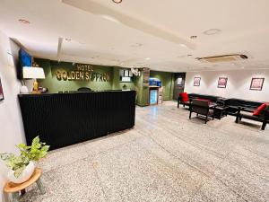 a lobby with a waiting area with a hotelcoach at Hotel Golden Saffron - Punjabi Bagh Delhi in New Delhi