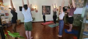 a group of people doing yoga in a room at Mad Vervet Nairobi Backpackers Hostel in Nairobi