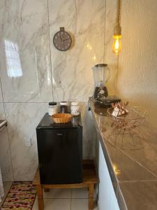 una cucina con un bancone con un frullatore e un orologio di Residência Saquarema a Saquarema Altre 9 foto