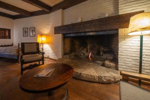 a living room with a fireplace and a table at La Gaviota in San Carlos de Bariloche