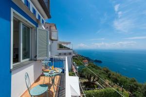 a balcony with a view of the ocean at Sogno Blu in Furore +40 photos