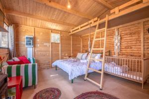 a bedroom with a bunk bed in a log cabin at Wooden House Apartments in Kaláthenai