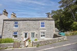 a stone house on the side of a road at Cumbria, en-suite bathrooms, North Pennines in Alston