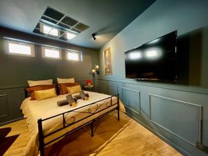 a bedroom with a bed with a large flat screen tv at Sleep'In Cities Le Saphir Balnéo in Albi