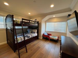 a bedroom with two bunk beds and a desk at Destination #29 in Anaheim