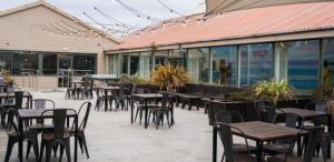 an empty patio with tables and chairs in a restaurant at Captivating 3-Bed Cabin in Prestonpans in Prestonpans
