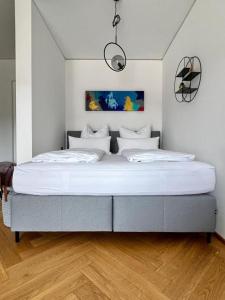 a large bed in a white room with a large mattress at Stylische Wohnung mit Balkon in Graz