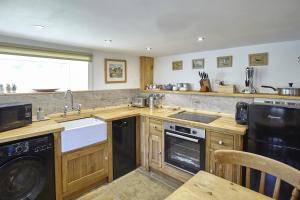 a kitchen with a sink and a dishwasher at Cumbria, en-suite bathrooms, North Pennines in Alston