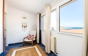 Habitación con silla y ventana en Villa Roxana, en Es Castell