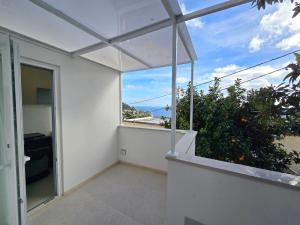 an empty balcony with a view of the ocean at Sopramonte Exclusive Rooms in Capri