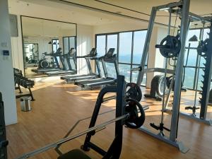 a gym with treadmills and weights in a building at Homesbyfs Youth City KLIA in Nilai