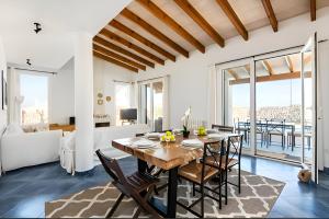 una sala da pranzo e un soggiorno con tavolo e sedie. di Villa Roxana a Es Castell