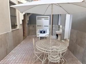 a table and chairs with an umbrella on a patio at CASA CAMILLA in Chioggia