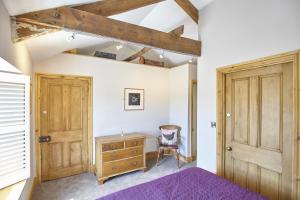 a bedroom with a wooden door and a wooden dresser at Cumbria, en-suite bathrooms, North Pennines in Alston
