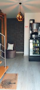 a room with a couch and a refrigerator with drinks at Pinhal Litoral in Marinha Grande