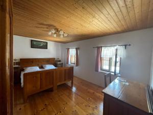 a bedroom with a bed and a wooden ceiling at Landliebe in Vorchdorf