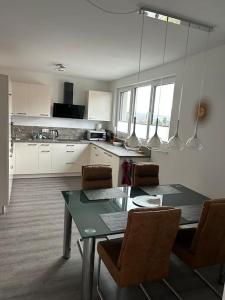 a kitchen with a dining room table and chairs at Exklusive Penthouse-Wohnung mit Blick über Marburg in Marburg an der Lahn