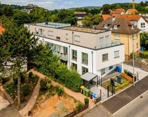 an aerial view of a white building with a street at Exklusive Penthouse-Wohnung mit Blick über Marburg in Marburg an der Lahn