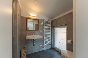 a bathroom with a sink and a mirror at Villa Patria B&B in Brusino Arsizio