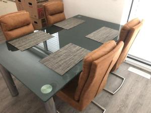 a dining room table with a green table and chairs at Exklusive Penthouse-Wohnung mit Blick über Marburg in Marburg an der Lahn