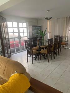 a living room with a dining room table and chairs at Casa familiar in Tacna