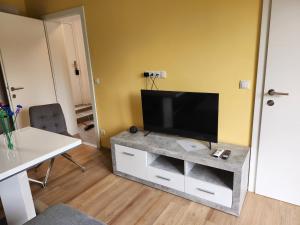 a living room with a flat screen tv on a table at Haus Yuphin in Hart bei Graz